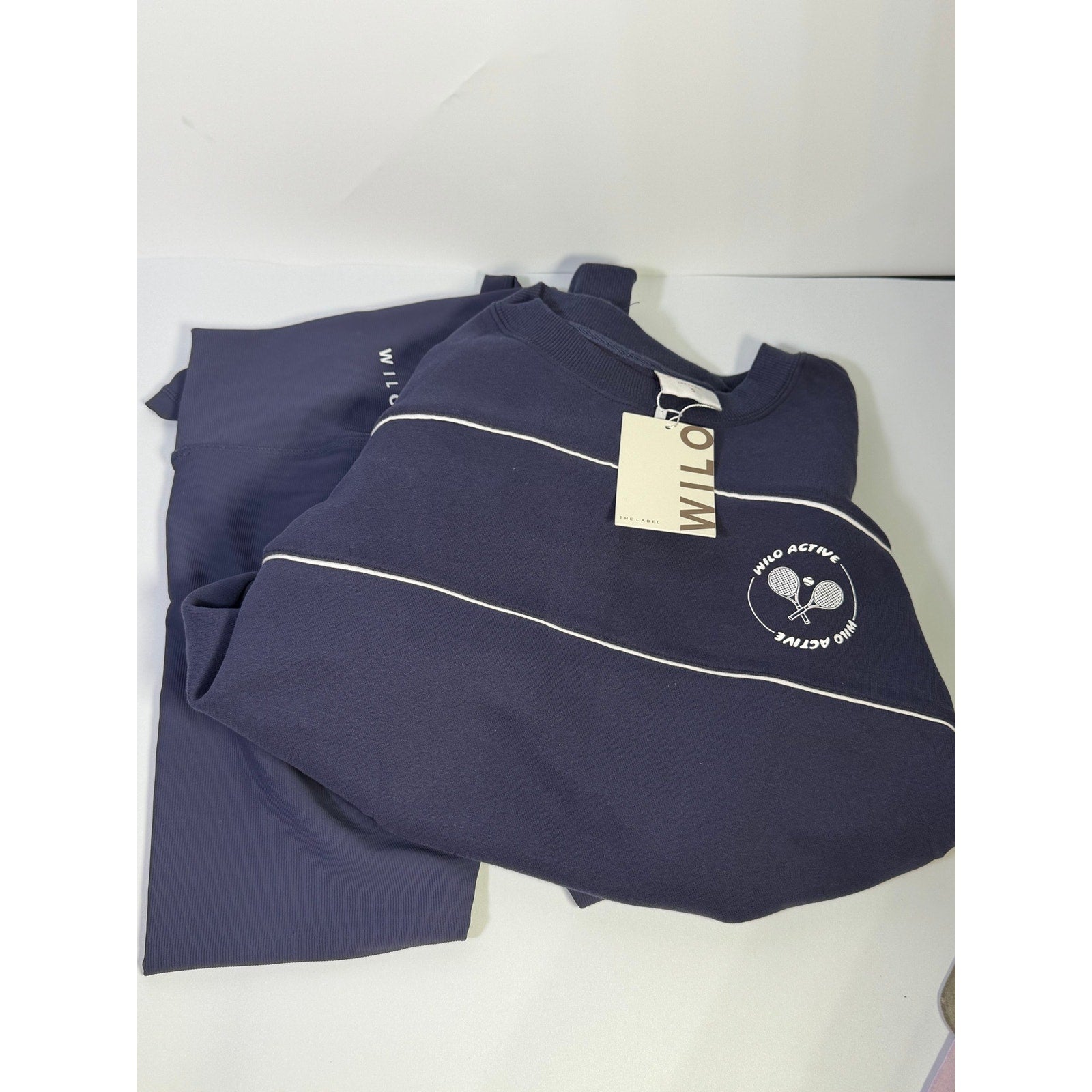 Wilo The Label women's navy 2-piece sweatshirt and leggings set, size small, featuring comfortable fabric and casual style.