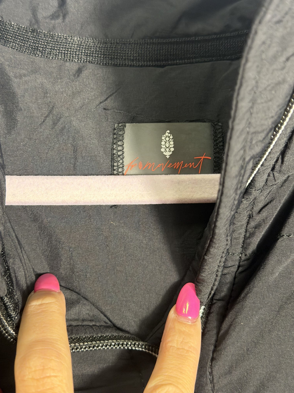 Black Free People Movement Pippa packable puffer jacket with PrimaLoft insulation, women's XS, shown folded and partially worn.
