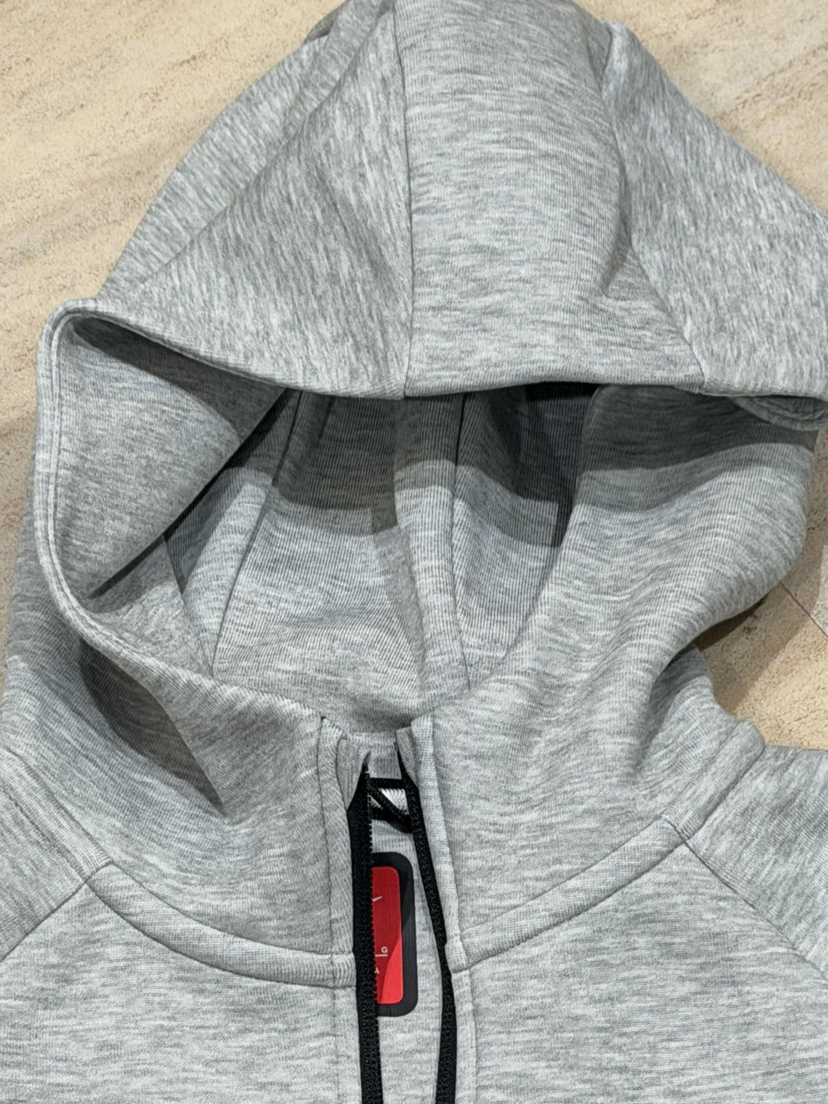 Nike Tech Fleece full-zip hoodie for big kids, dark grey Heather with black accents, size L, front view showing hoodie and zipper.
