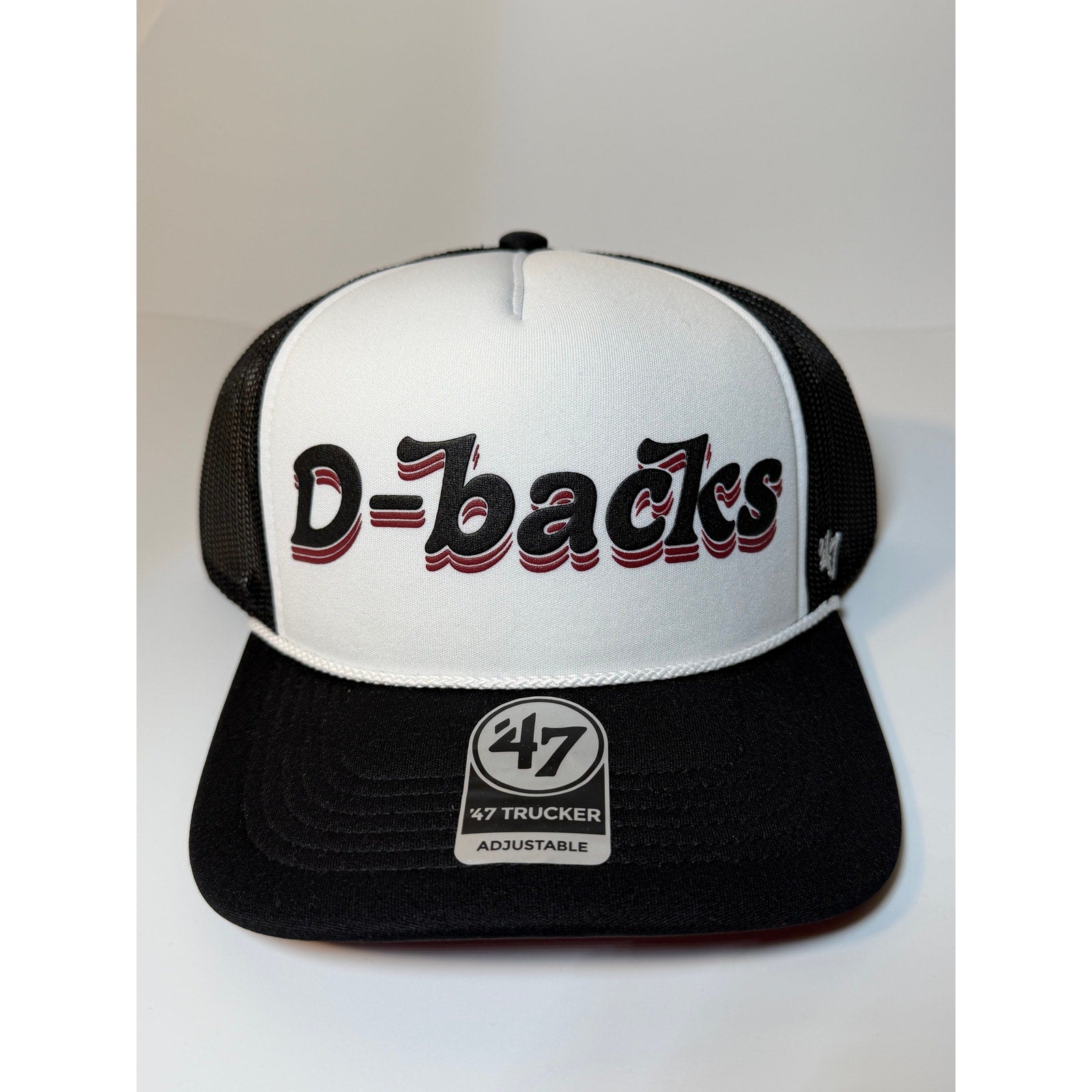Black and white 47 Brand Arizona Diamondbacks trucker hat with adjustable strap, featuring team logo and mesh back for ventilation.