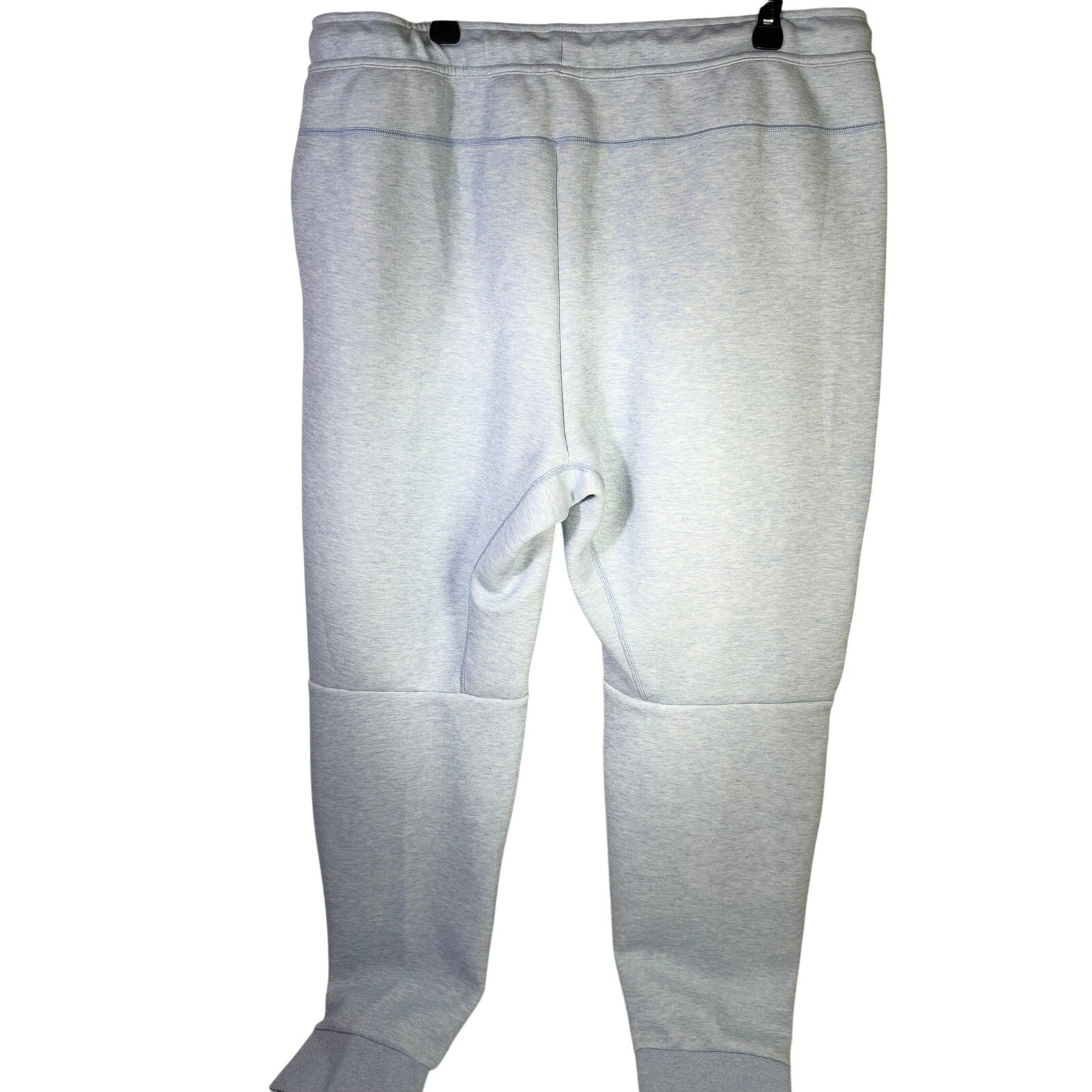 Light blue Heather Nike Sportswear Tech Fleece jogger pants for men, size XXL, showing relaxed fit and fleece material.