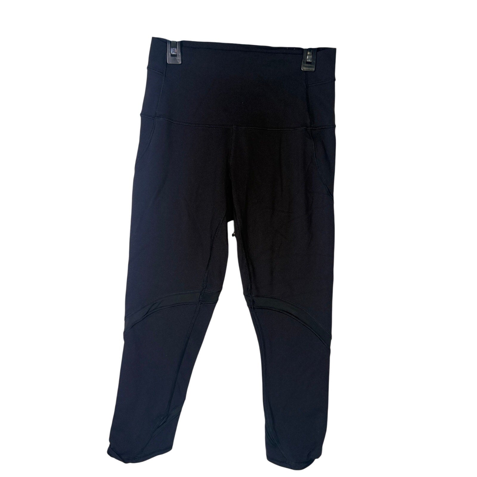 Lululemon women’s high-rise paneled cropped black leggings, size 6, with stretchy fabric and sleek design.