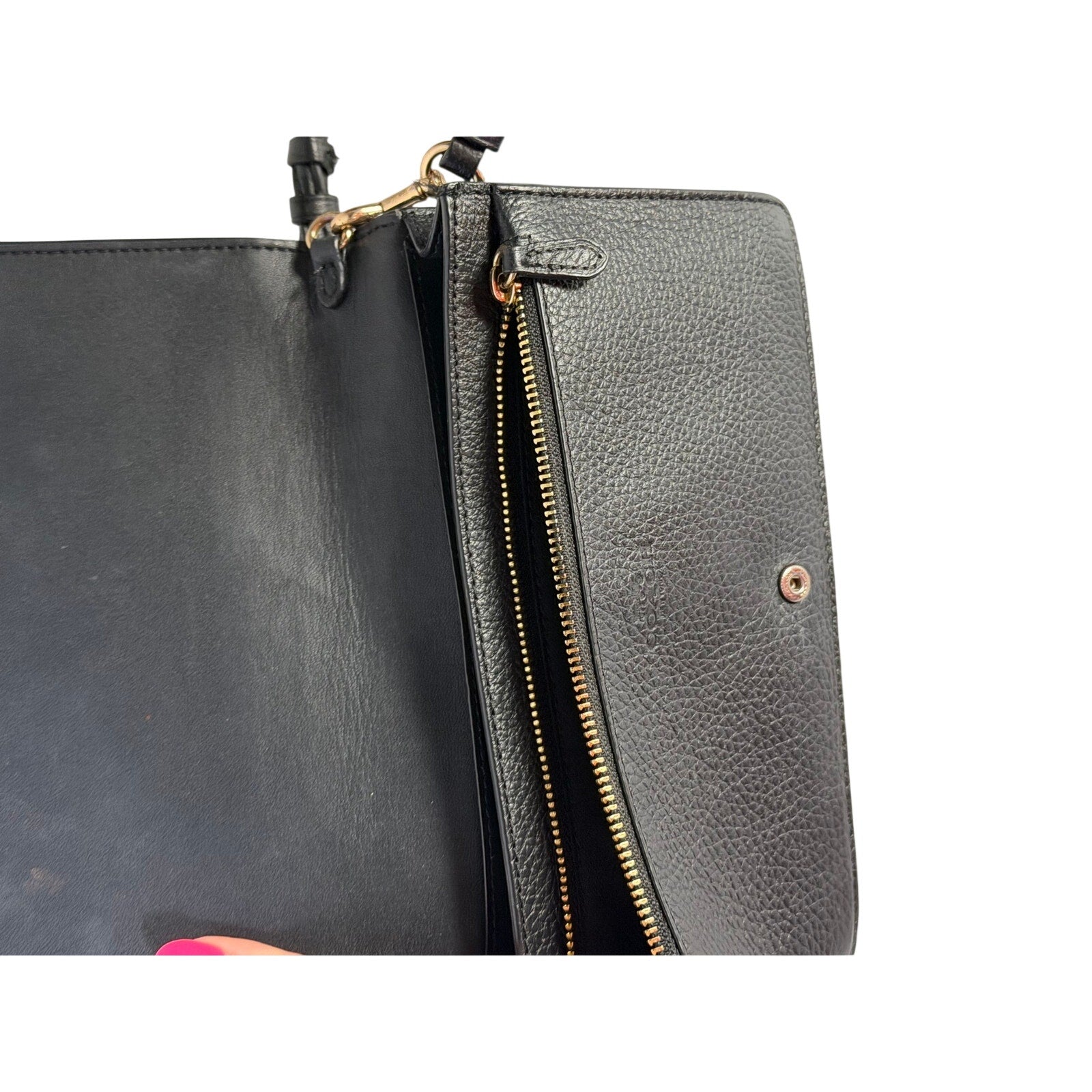 Coach women's black leather foldover crossbody wallet bag with adjustable strap, featuring a sleek handbag design.