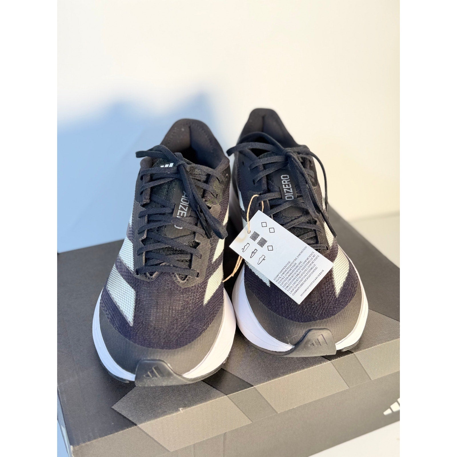 Men's Adidas Adizero SL2 athletic running shoes in black and white with Lightstrike cushioning, size 6.5.
