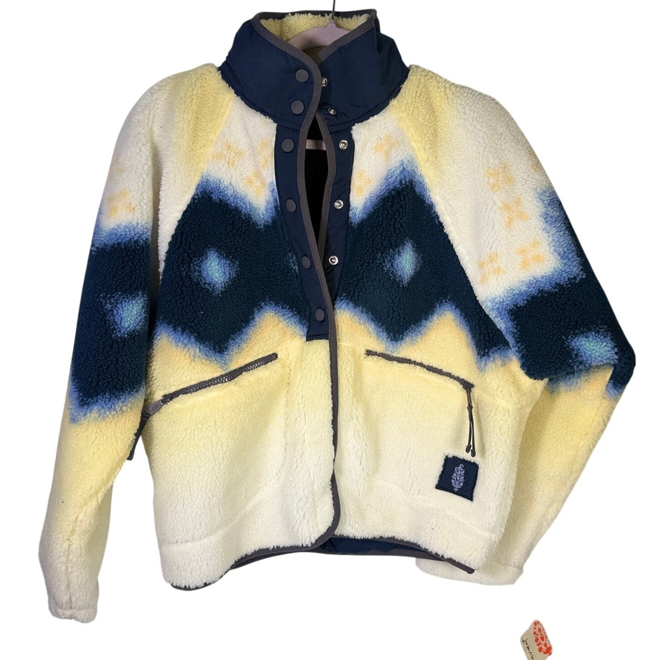 Free People women’s Soft Glow Sun Combo fleece jacket in yellow and blue, size S, displayed on a hanger.