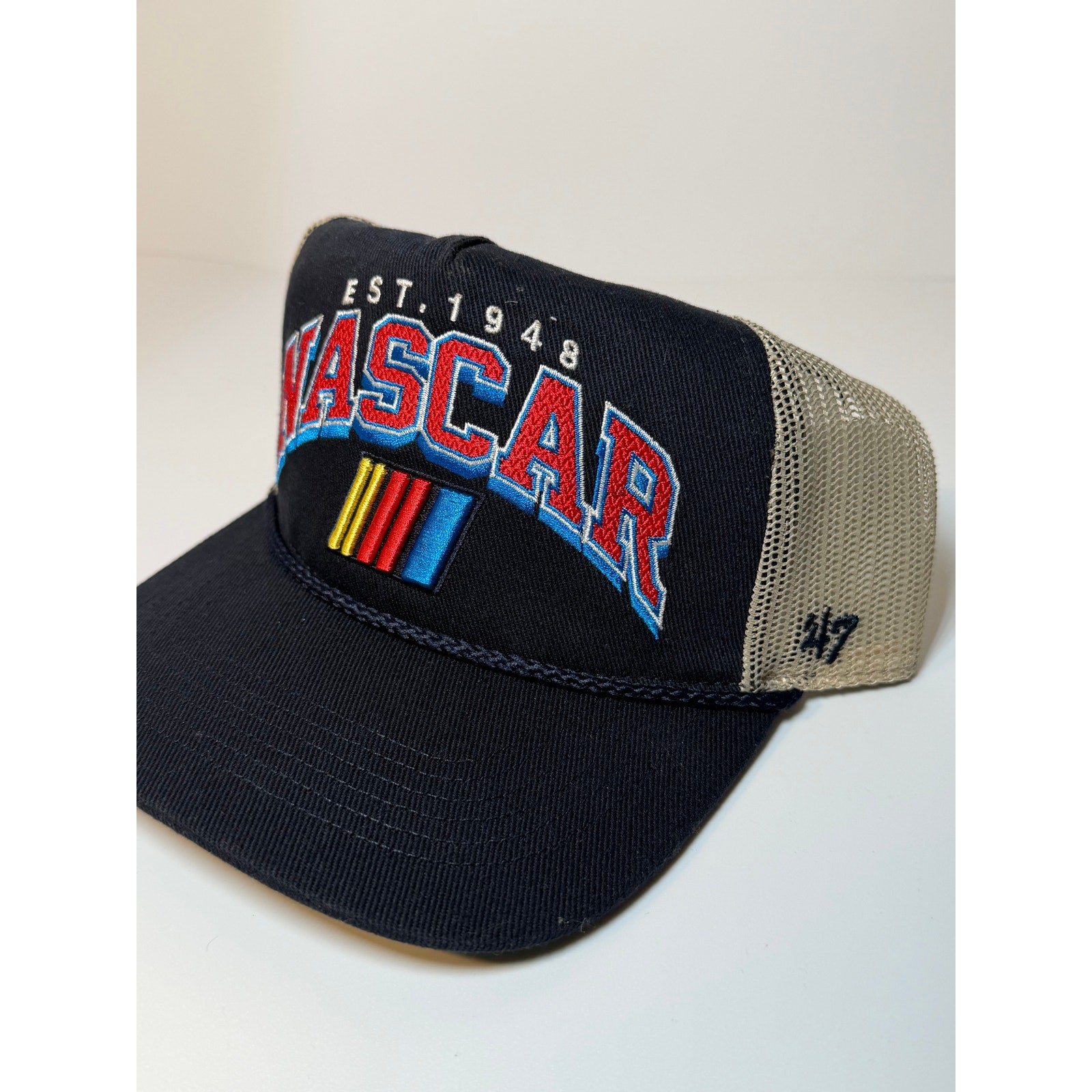 Navy and tan 47 Brand NASCAR trucker hat with embroidered EST. 1948 logo, adjustable snapback, one size fits all.