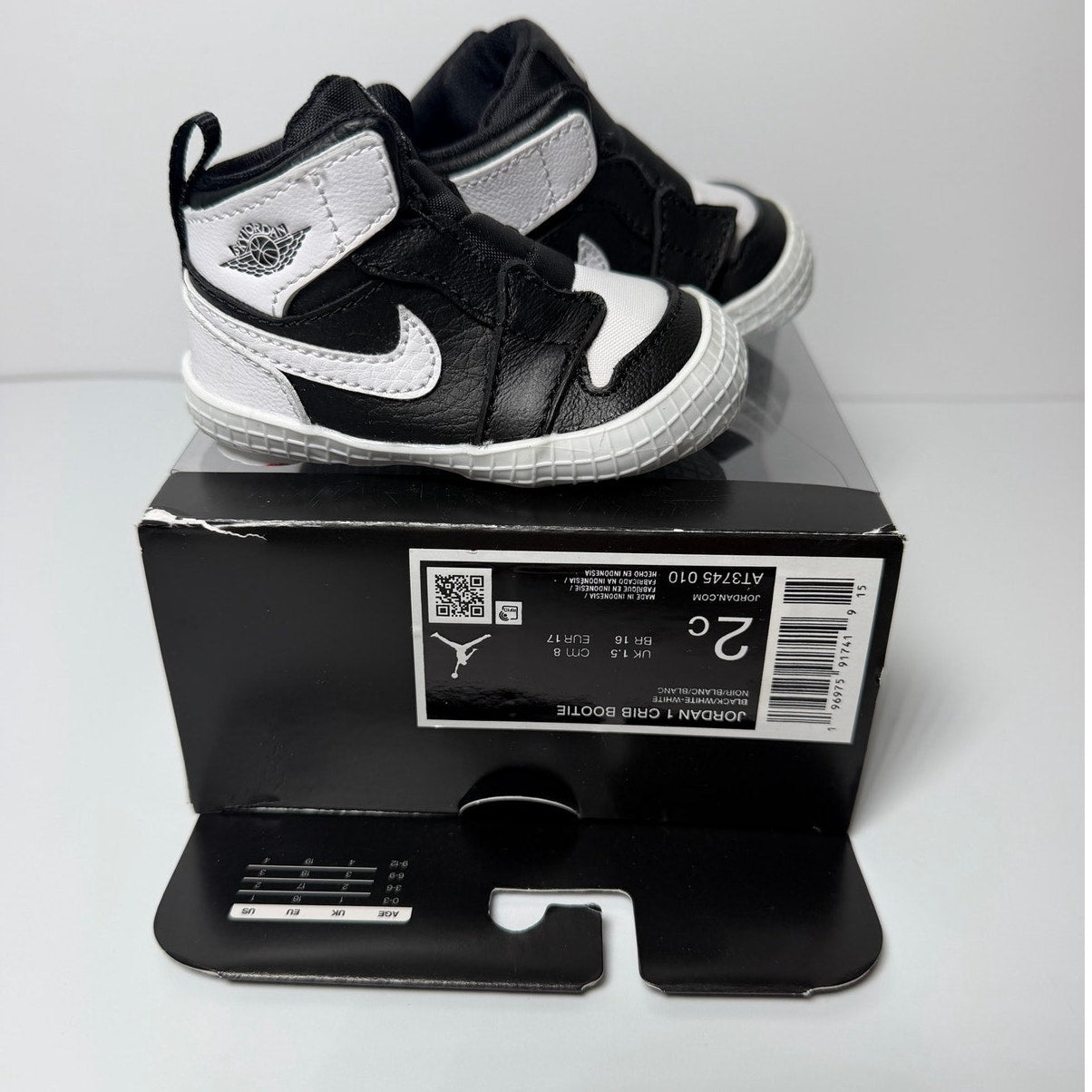 Infant Nike Air Jordan 1 Retro High OG sneakers in black and white, toddler size 2C, with classic high-top design.