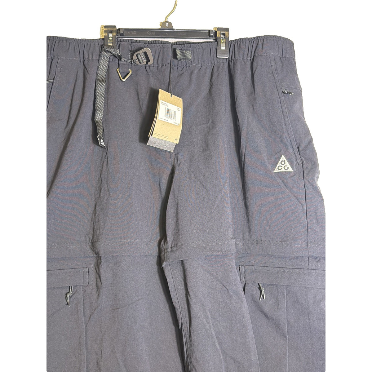 Nike ACG women's black convertible zip-off cargo hiking pants with multiple pockets, size XXL, displayed flat.
