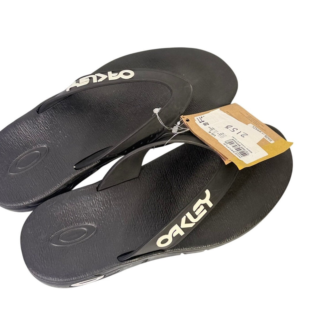 Black Oakley B1B flip flops for men, US size 8, casual sandals with comfortable straps and open-toe design.