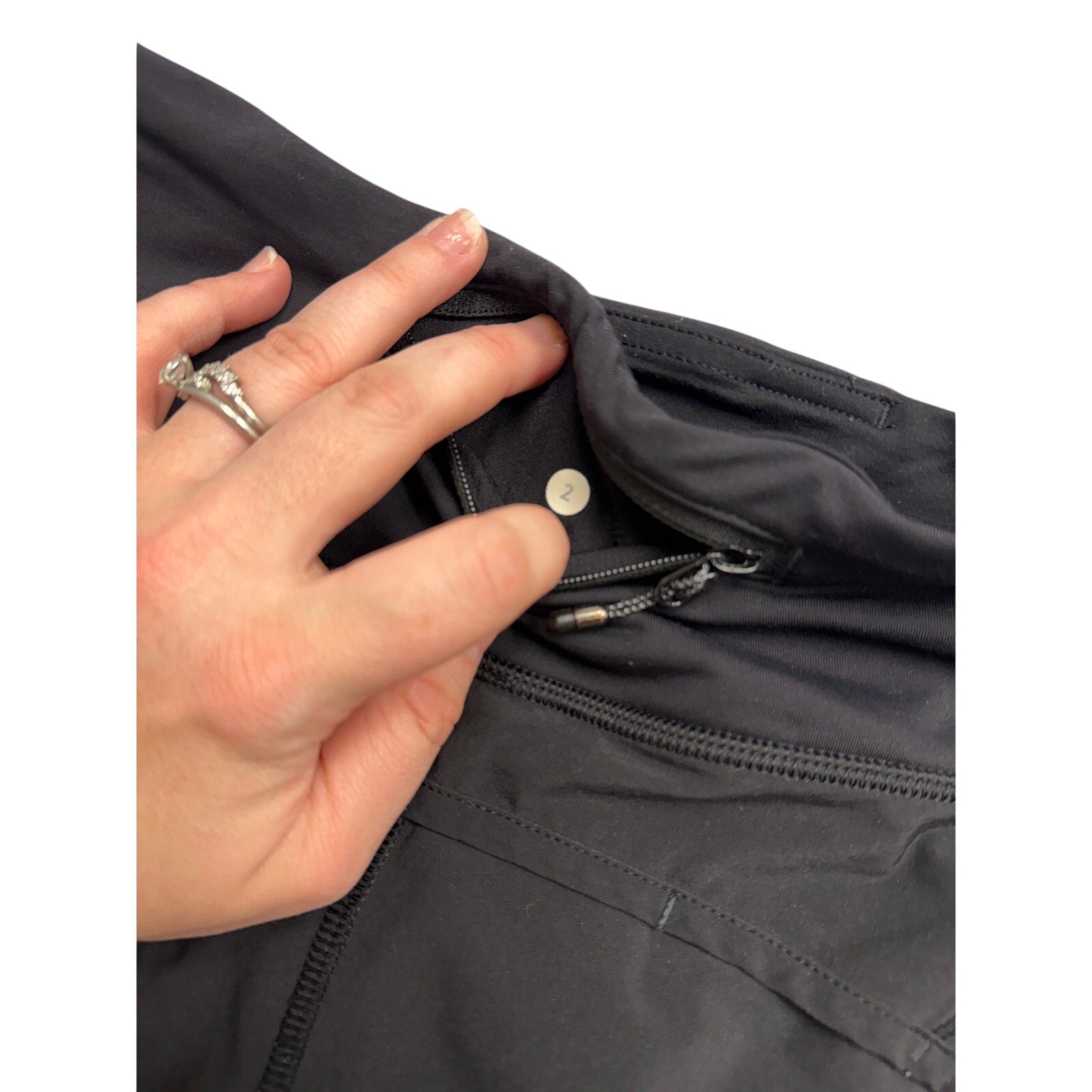 Alyssa women's black athletic running shorts with a zip back pocket, size 2, made for active wear and comfortable movement.