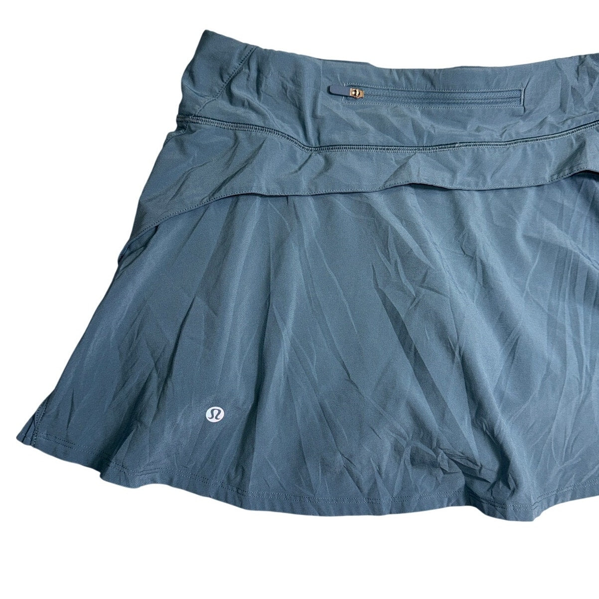 Lululemon Athletica women's ruffle pleated skirt in size 8 with back pocket, showing the stylish skirt's fabric and design.