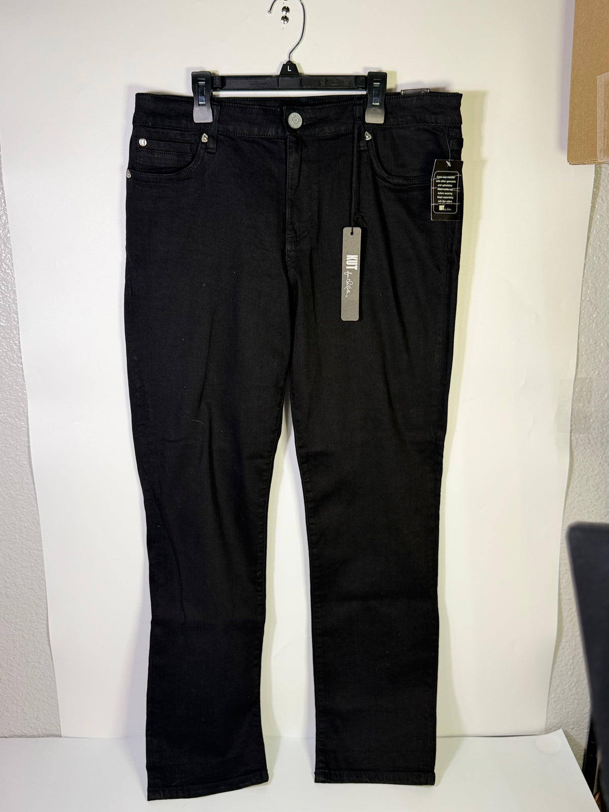 Black KUT from the Kloth straight leg jeans in size 12, shown on a hanger with visible stitching and classic denim texture.
