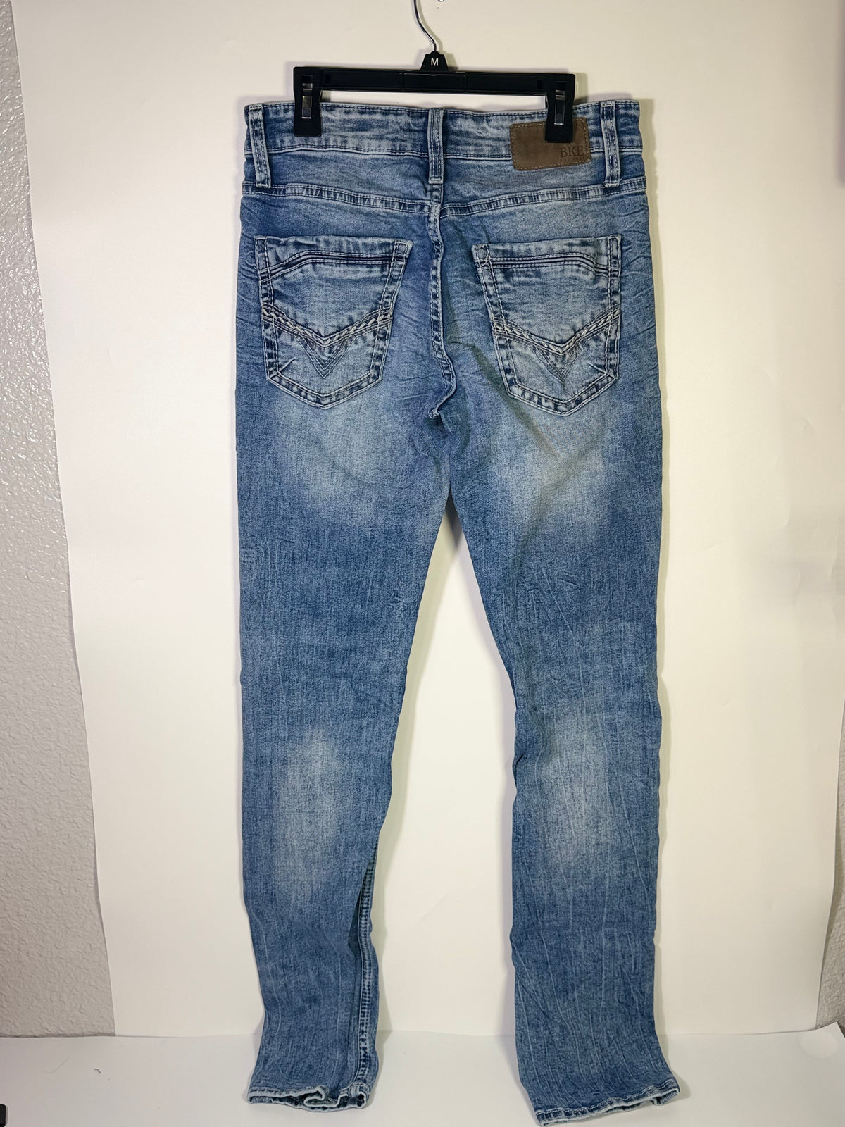 Light wash BKE Men’s Tyler straight leg jeans in size 29x34, denim clothing with classic fit and visible front and back pockets.