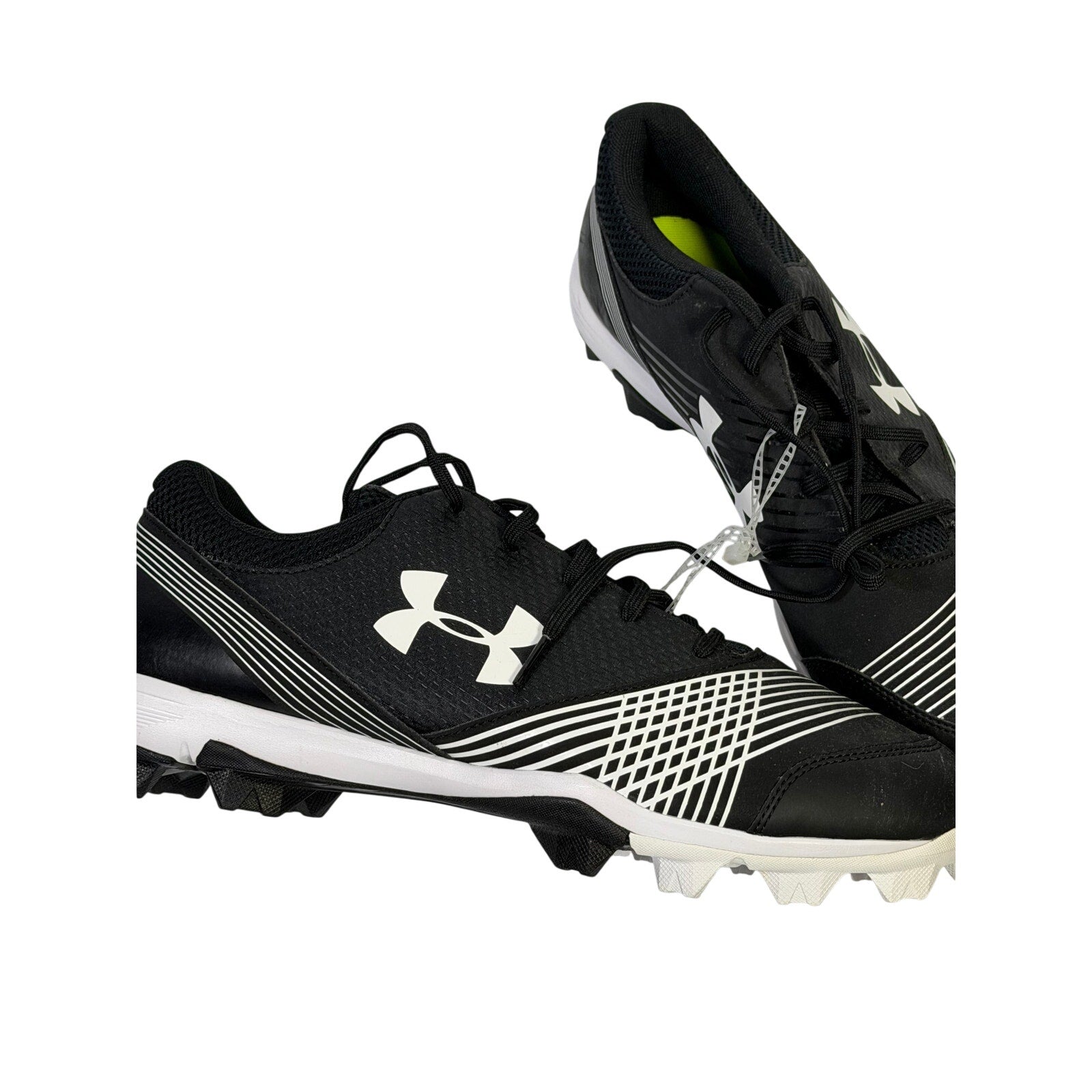 Under Armour men's black and white baseball cleats, size 12, molded athletic shoes with cleated outsole for baseball gameplay.