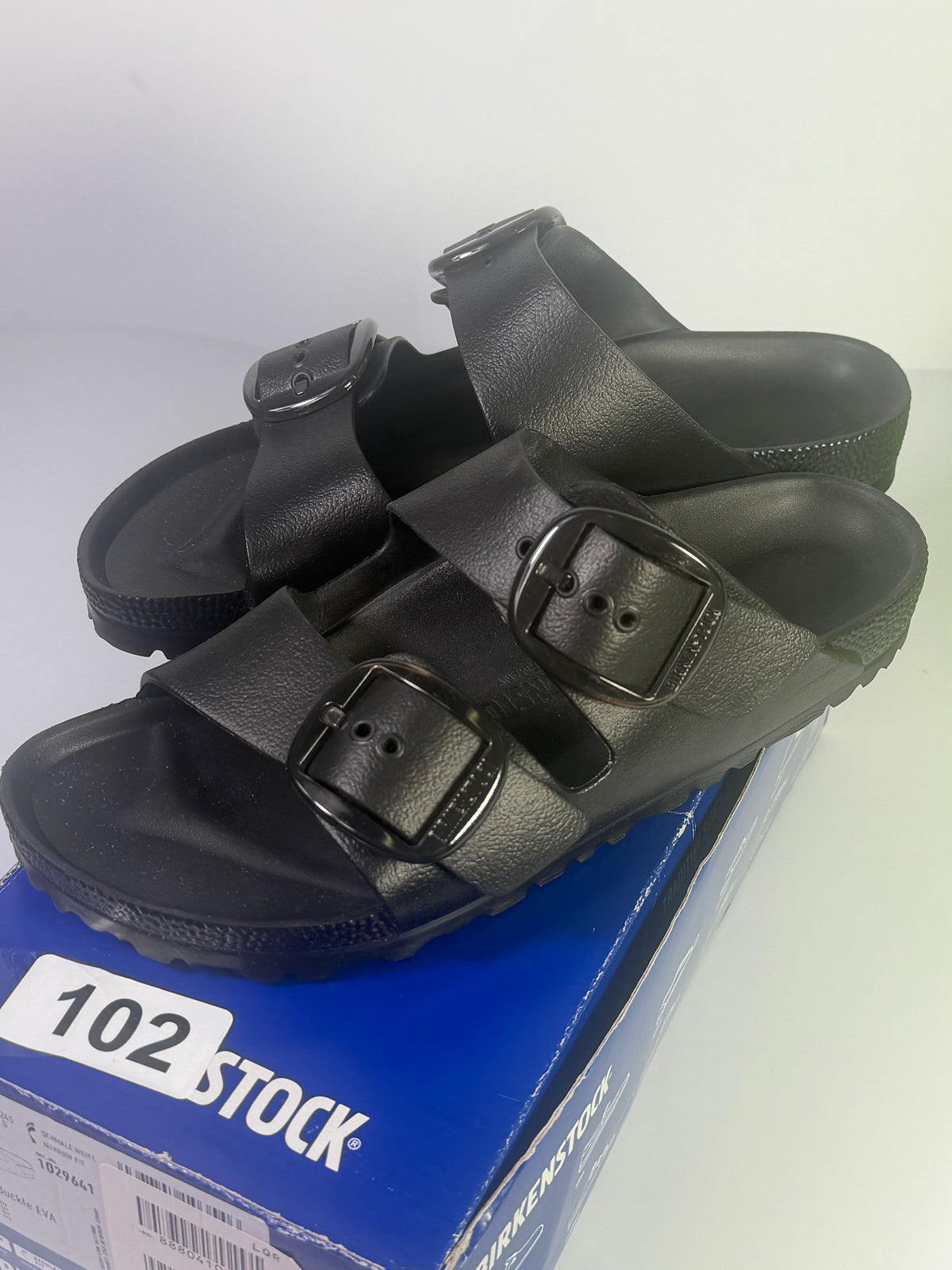 Black Birkenstock Arizona EVA sandals with big buckle, narrow fit, women's size US 7 / EU 38, lightweight and comfortable.