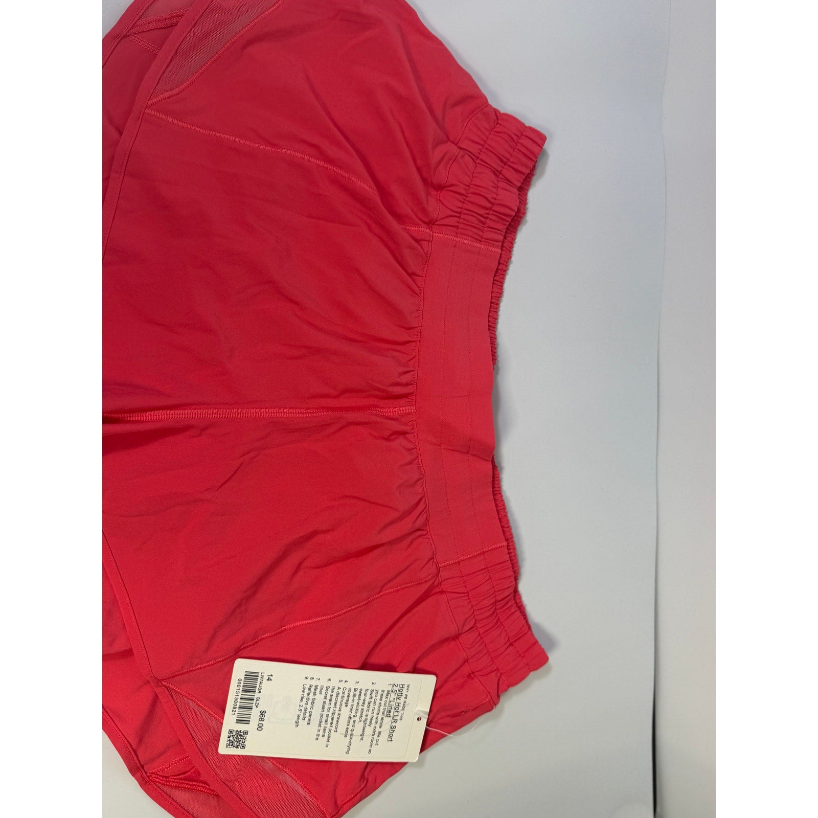 Lululemon Hotty Hot lined shorts in glaze pink, low rise, 2.5-inch length, women's size 14, with visible lining and lightweight fabric.