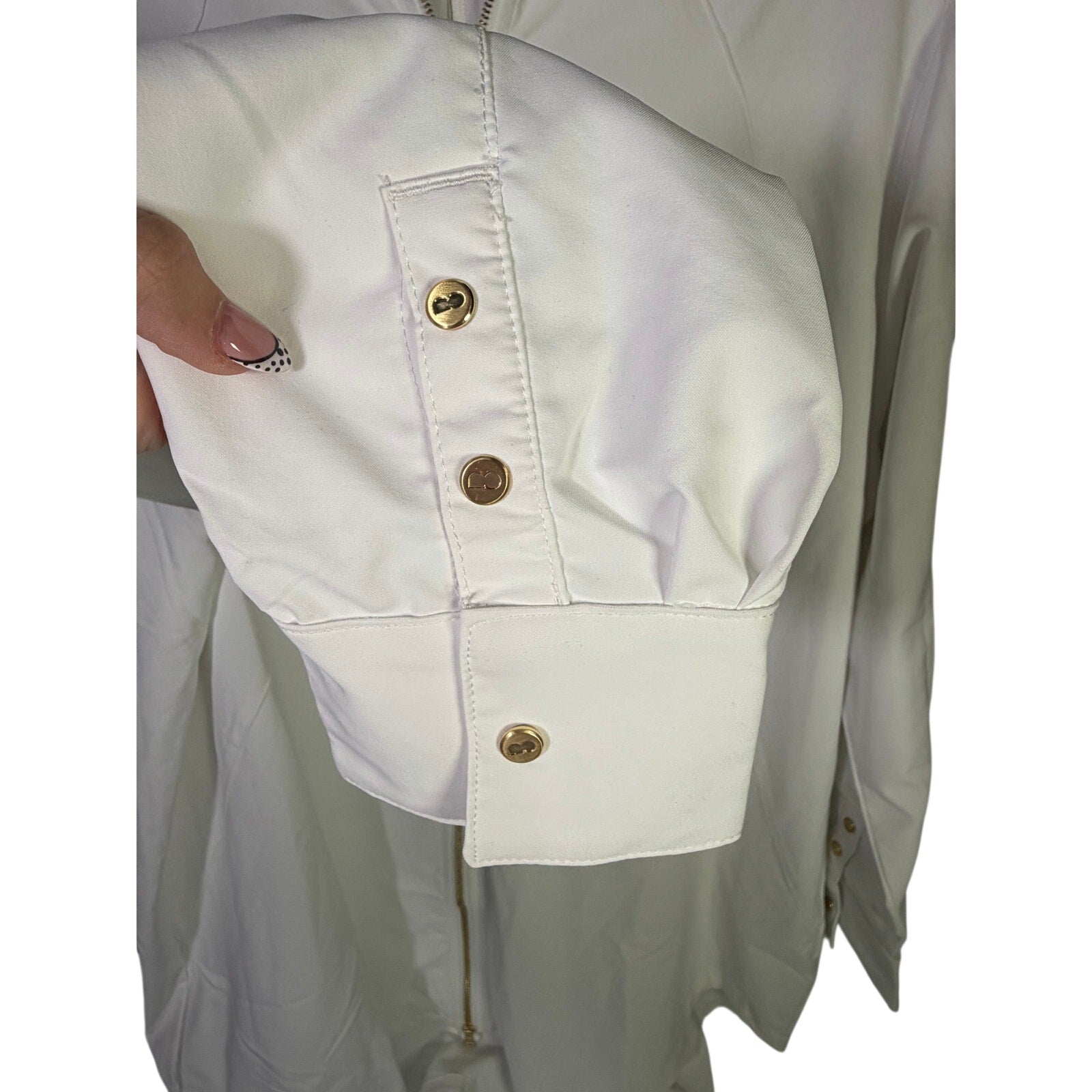 Nike women's long full zip jacket in cream, size XL, featuring Nike logo, displayed on a hanger.