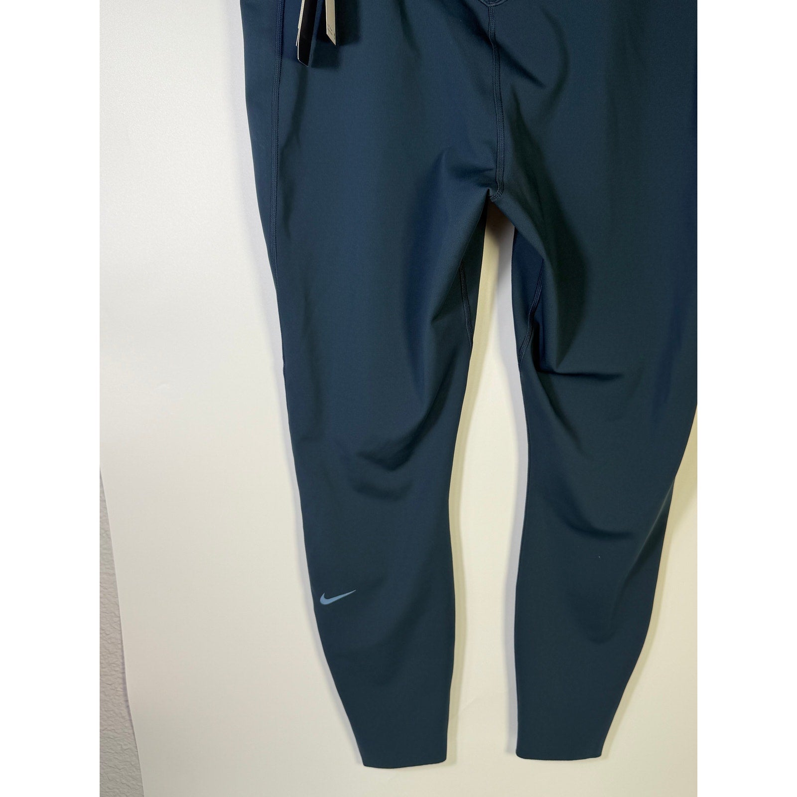 Nike Women's blue high-waisted training leggings in size XL, close-up view highlighting the stretchy fabric and comfortable fit.