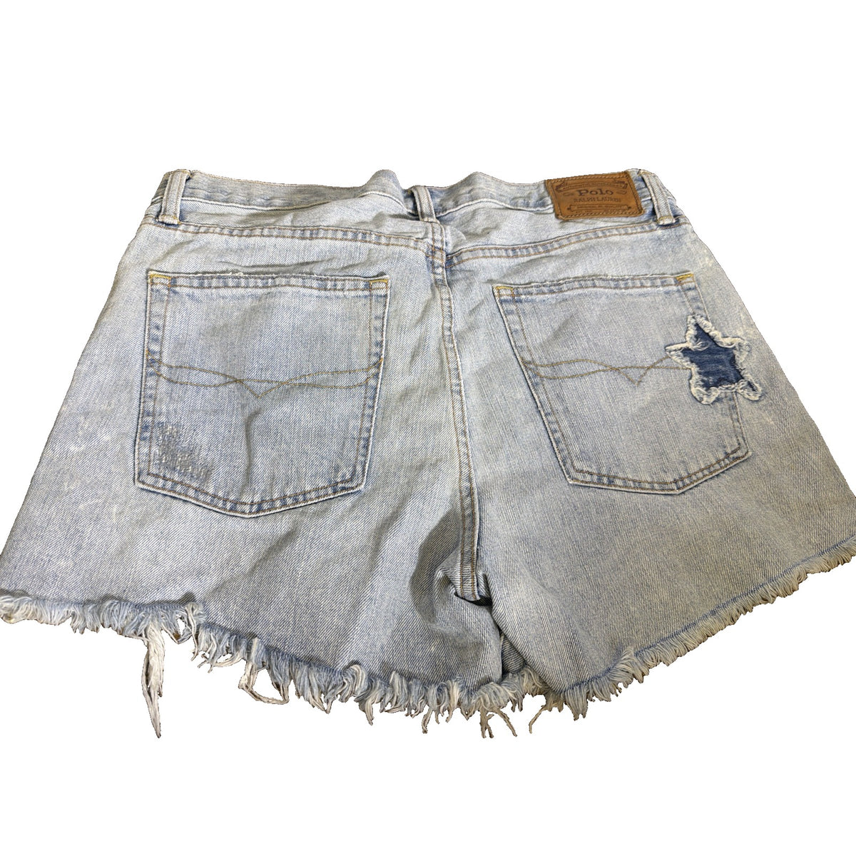 Light wash Polo Ralph Lauren women's distressed star patch denim cutoff shorts, size 29, with frayed hems and star patches visible.