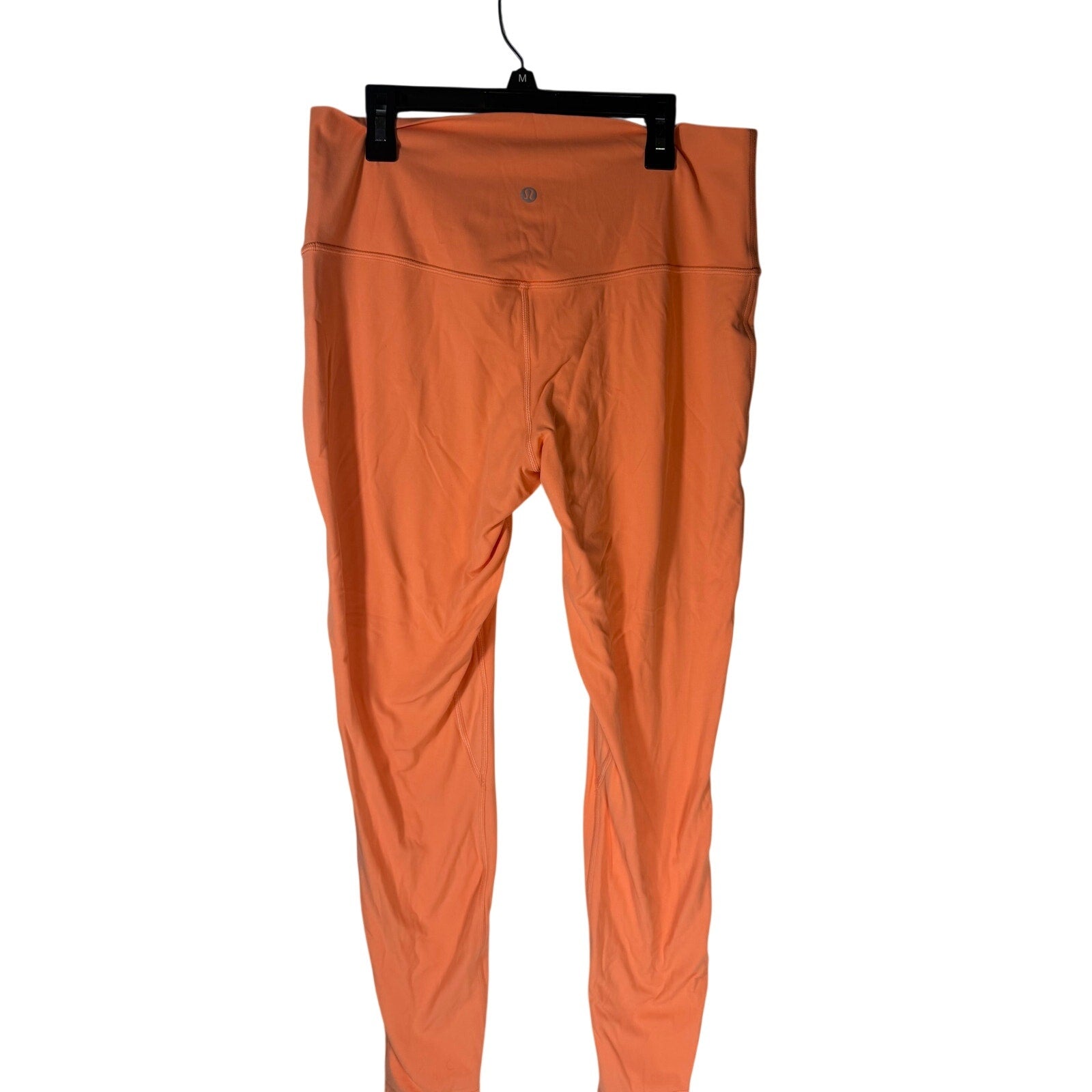 Lululemon women's high-rise burnt orange leggings size 12, stretchy athletic leggings with a smooth fit and comfortable waistband.