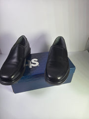 Black SAS men's leather slip-on loafers in size 11.5 wide, featuring a sleek flat design, new in box.