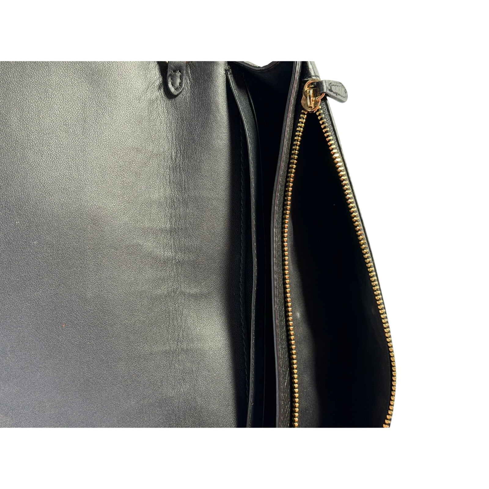 Coach women's black leather foldover crossbody wallet bag with adjustable strap, featuring a sleek handbag design.