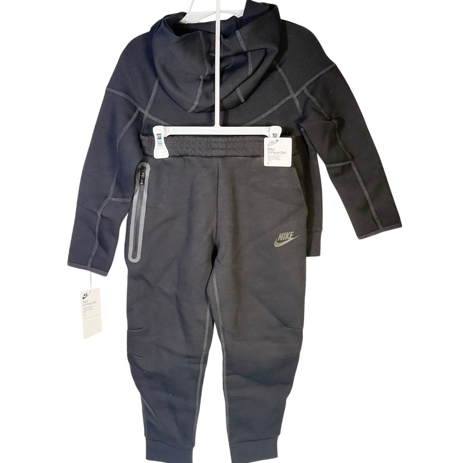 Nike kids tech fleece full-zip hoodie and jogger set in black, size 7, featuring Nike branding and comfortable, sporty design.