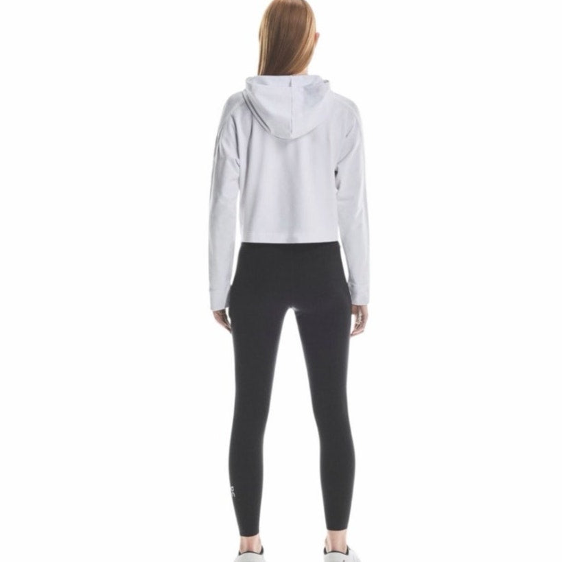 On Women's Train Tights 7/8 leggings in black, size M, showing smooth fabric and fitted design for active wear.