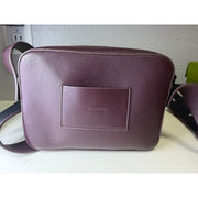AllSaints women's burgundy pebbled leather camera crossbody bag with adjustable strap and compact design.