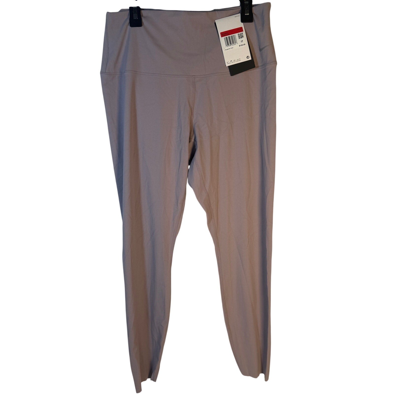 Nike women's taupe Go High Rise full-length training leggings, large size, shown laid flat with stretch fabric and waistband.