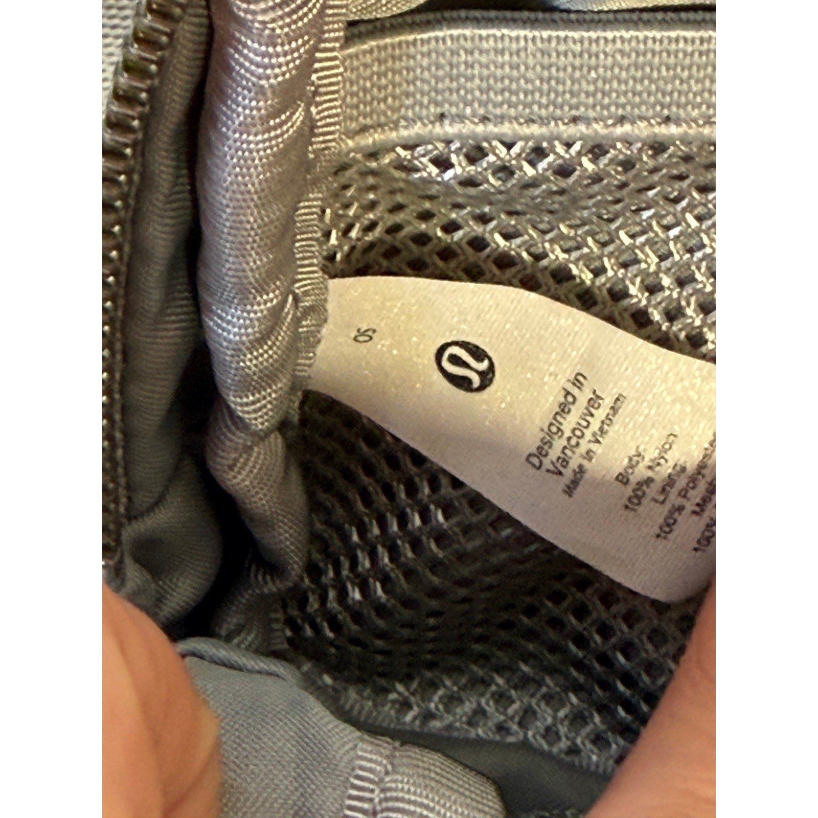 Light gray Lululemon Everywhere Belt Bag, a compact crossbody waist pack with adjustable strap and zippered compartments.