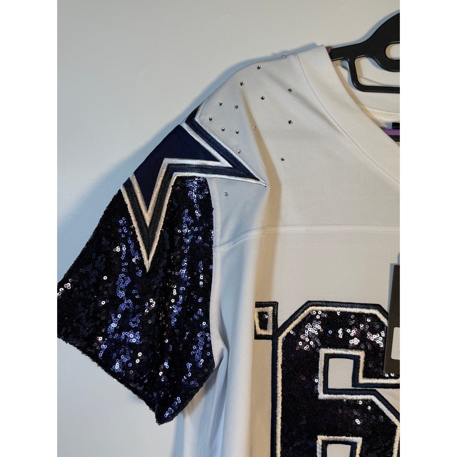 White Dallas Cowboys sequin jersey for women by Wear by Erin Andrews, size large, featuring NFL team logo and shiny sequin details.