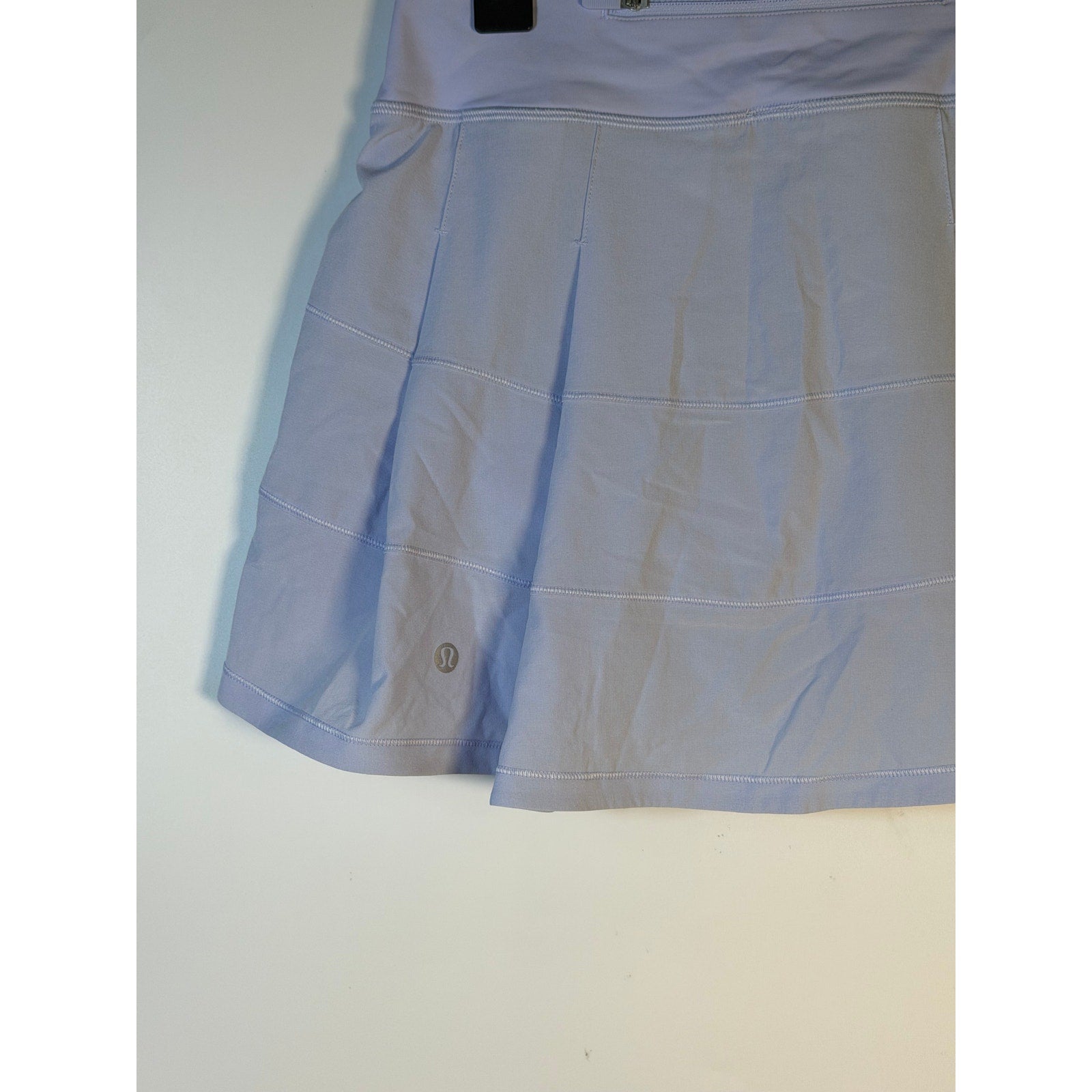 Lululemon women's light blue tennis skort, size 2, athletic activewear skirt with built-in shorts and a comfortable waistband.