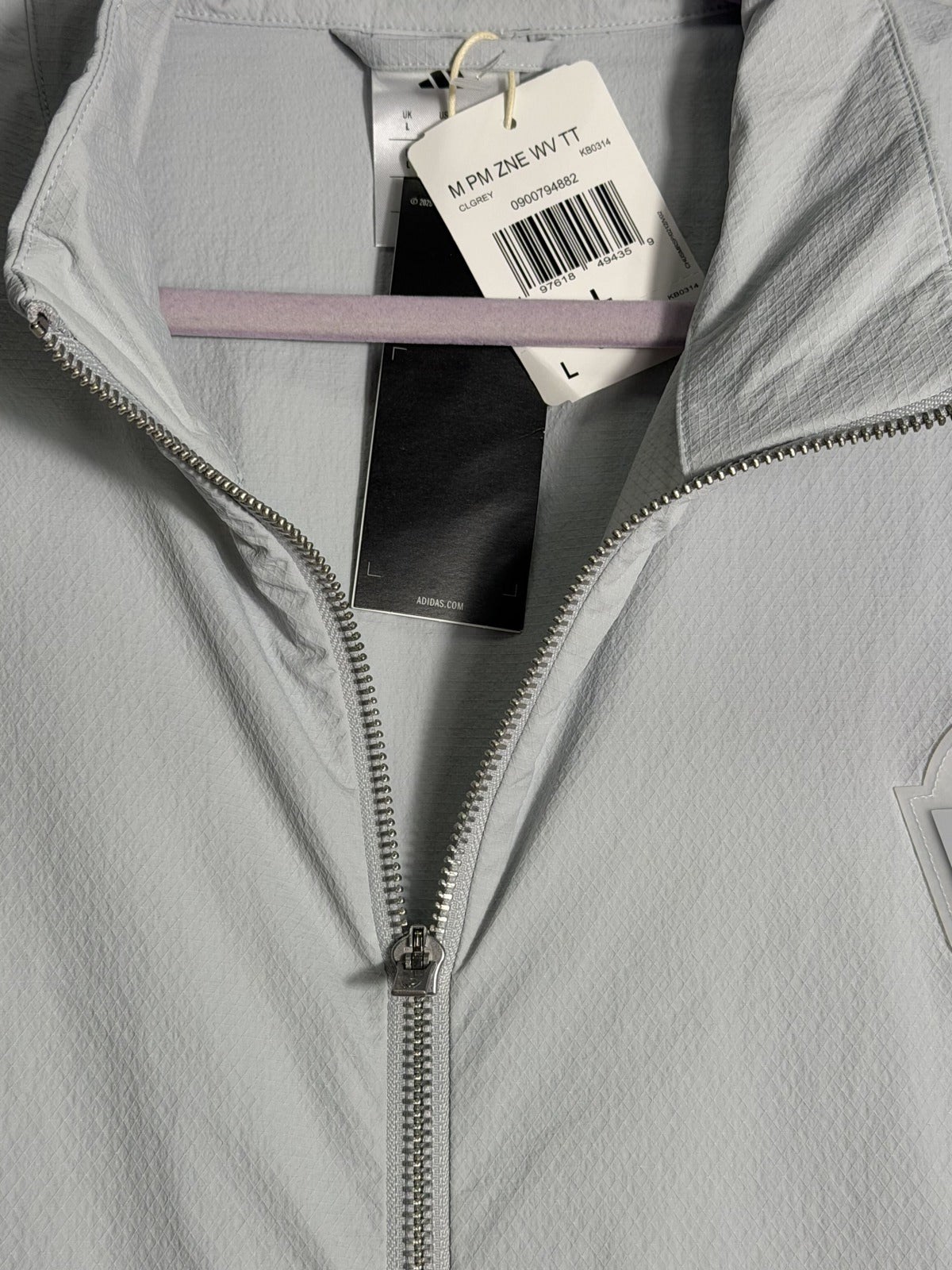 adidas Patrick Mahomes Z.N.E. woven track jacket in clear grey for men, showing front view with zip closure and logo details