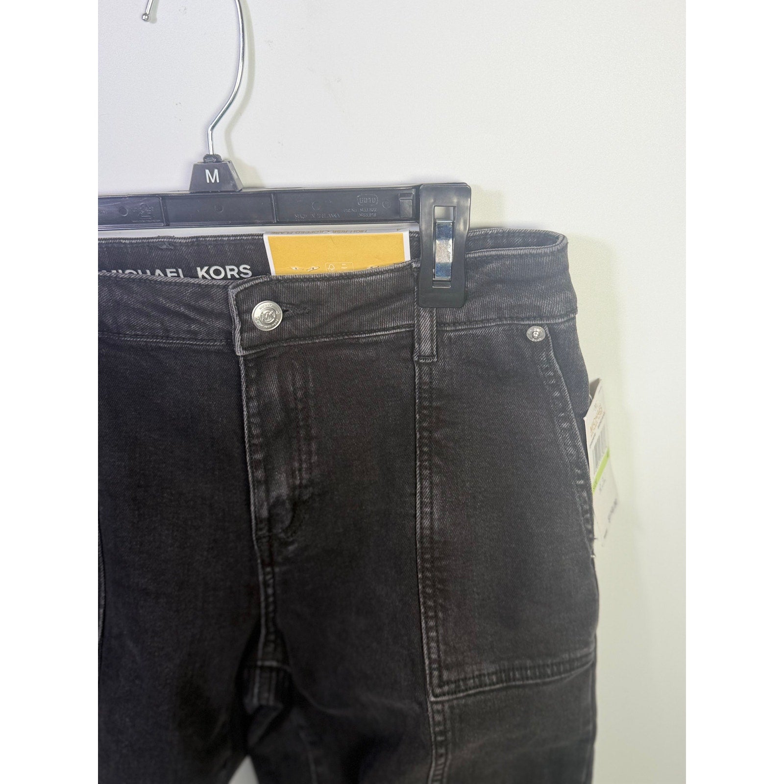 Michael Kors women's cropped flare jeans in washed black, size 4, featuring a high-waisted fit and distressed details.