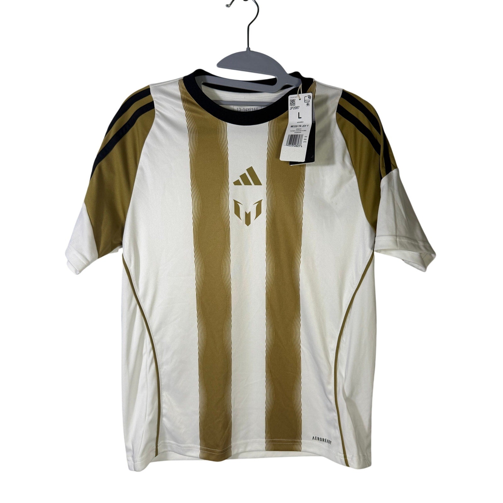 Youth large Adidas Messi training soccer jersey in white and gold, featuring team logo and breathable fabric.