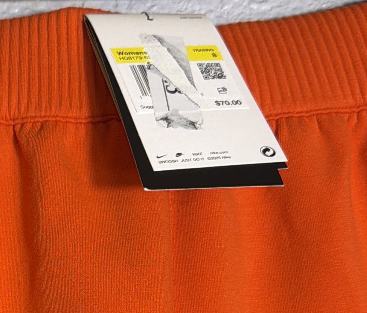 Nike 24.7 women's high-waisted knit shorts in orange, size small, featuring a comfortable elastic waistband and soft fabric.