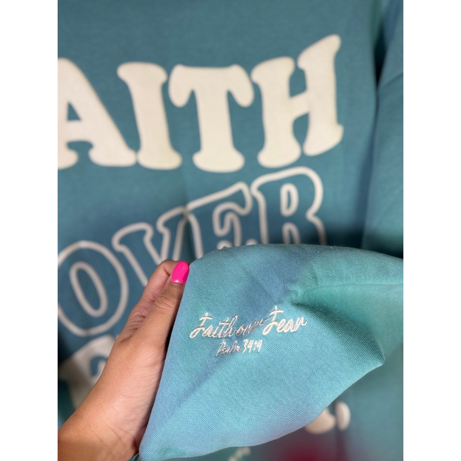 Seventh & Sunset Faith Over Fear green Christian crewneck sweatshirt displayed on a hanger, medium size, new with tags.