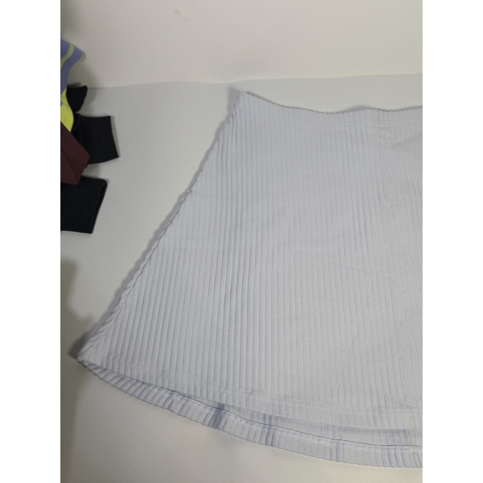 Nike women's ribbed mini skirt in sapphire mist color, size M, featuring a fitted design and soft ribbed fabric.