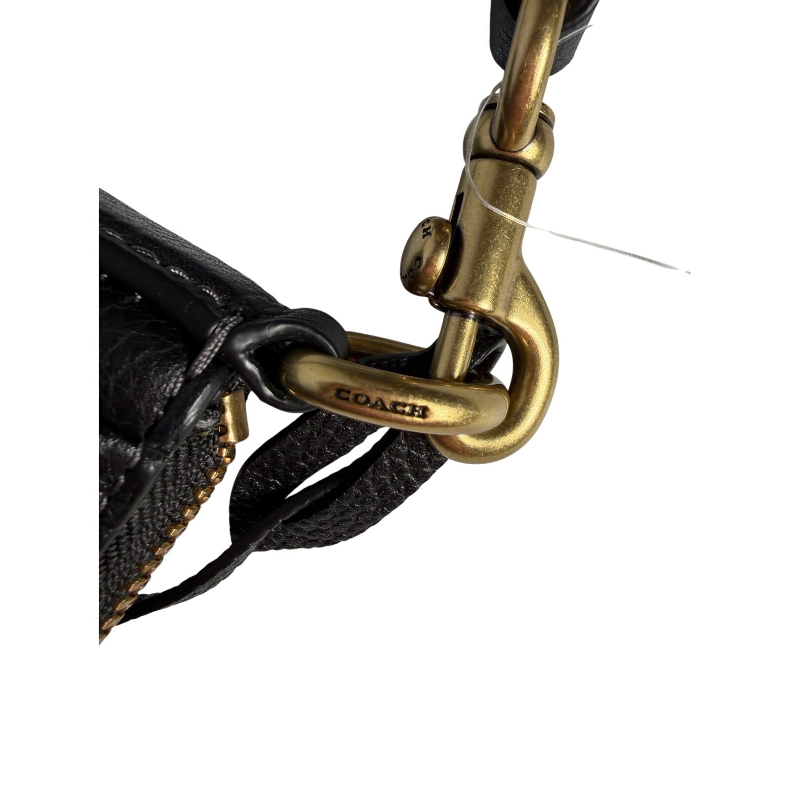 Coach women's black pebbled leather crossbody handbag with gold-tone hardware, featuring a compact shoulder bag design.