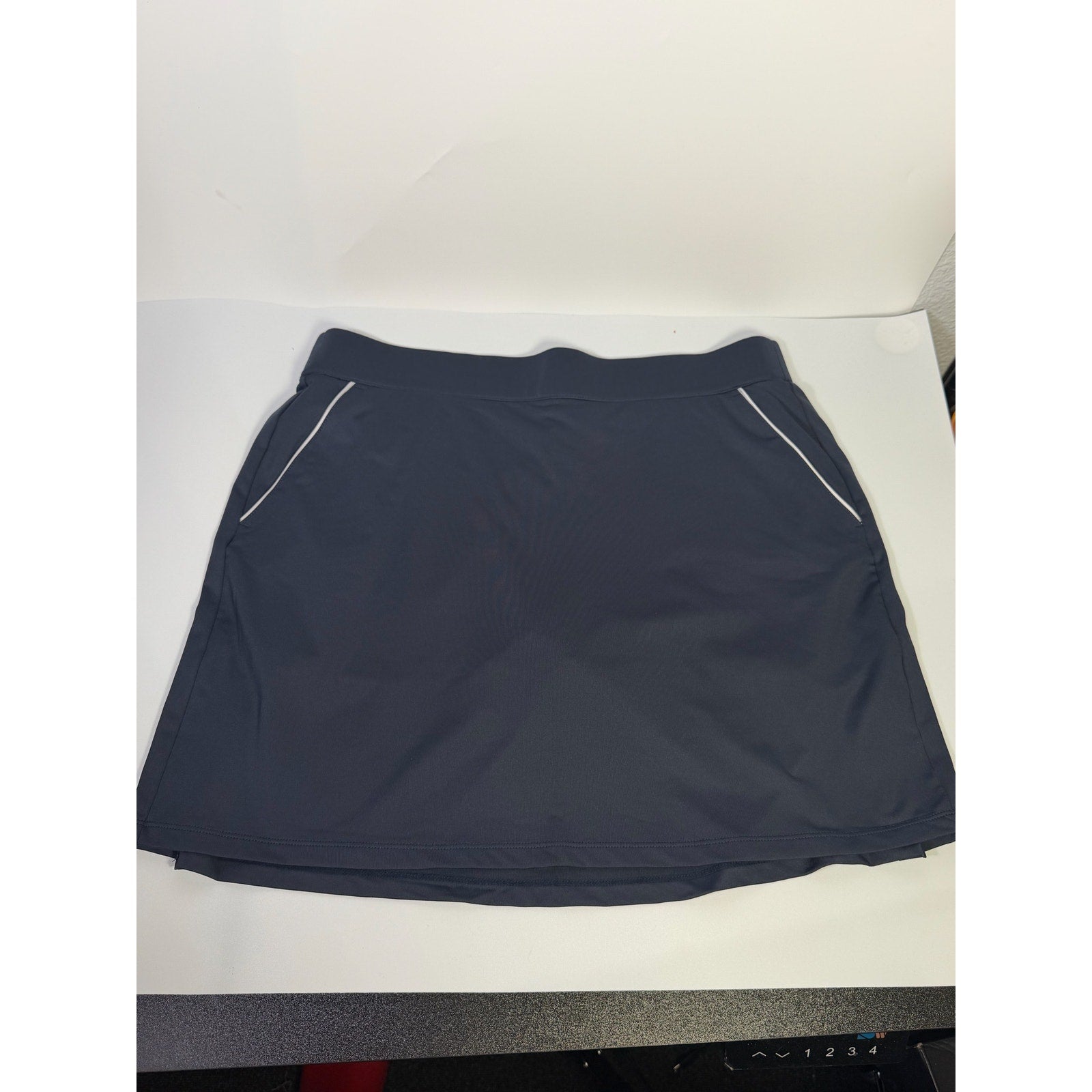 Dunning women's navy golf skort with built-in athletic shorts, size L, featuring a sleek, sporty design and comfortable fit.