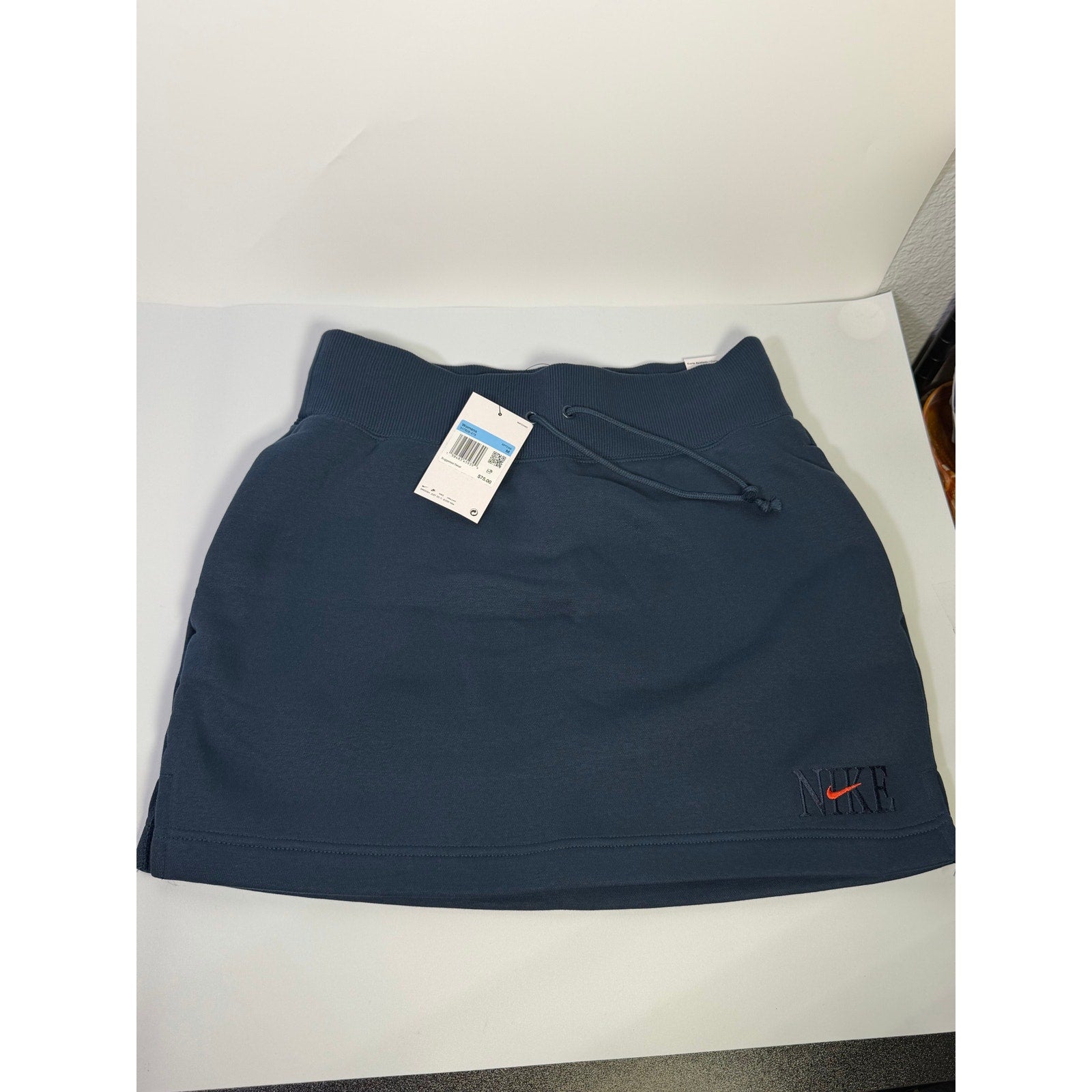 Nike women's navy blue fleece drawstring mini skirt, size M, showcasing the cozy fabric and stylish fit.