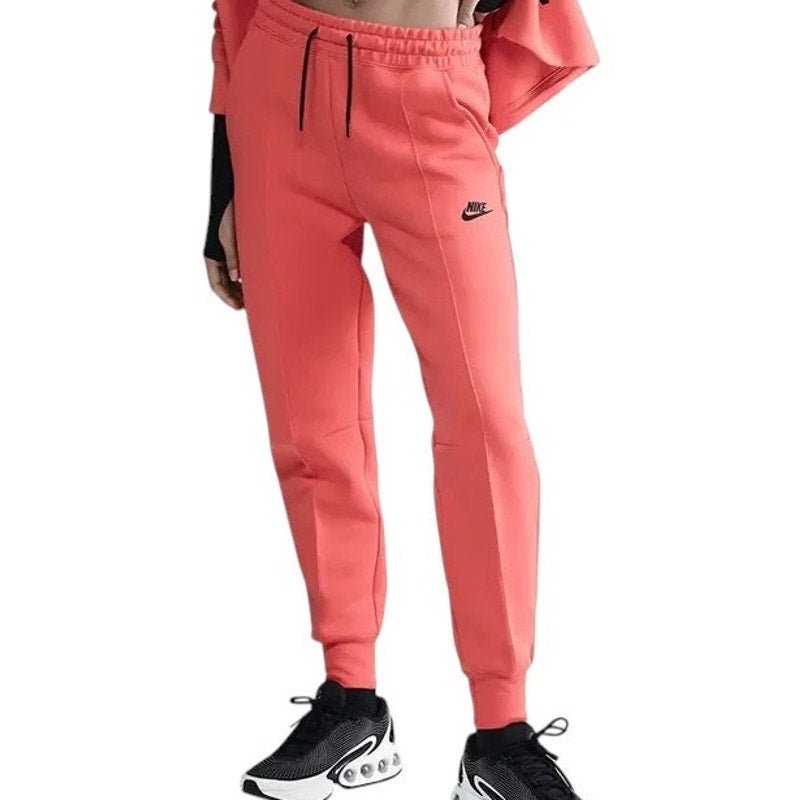 Nike Tech Fleece women's jogger pants in medium size, mid-rise, standard fit with athletic style and tapered leg design.