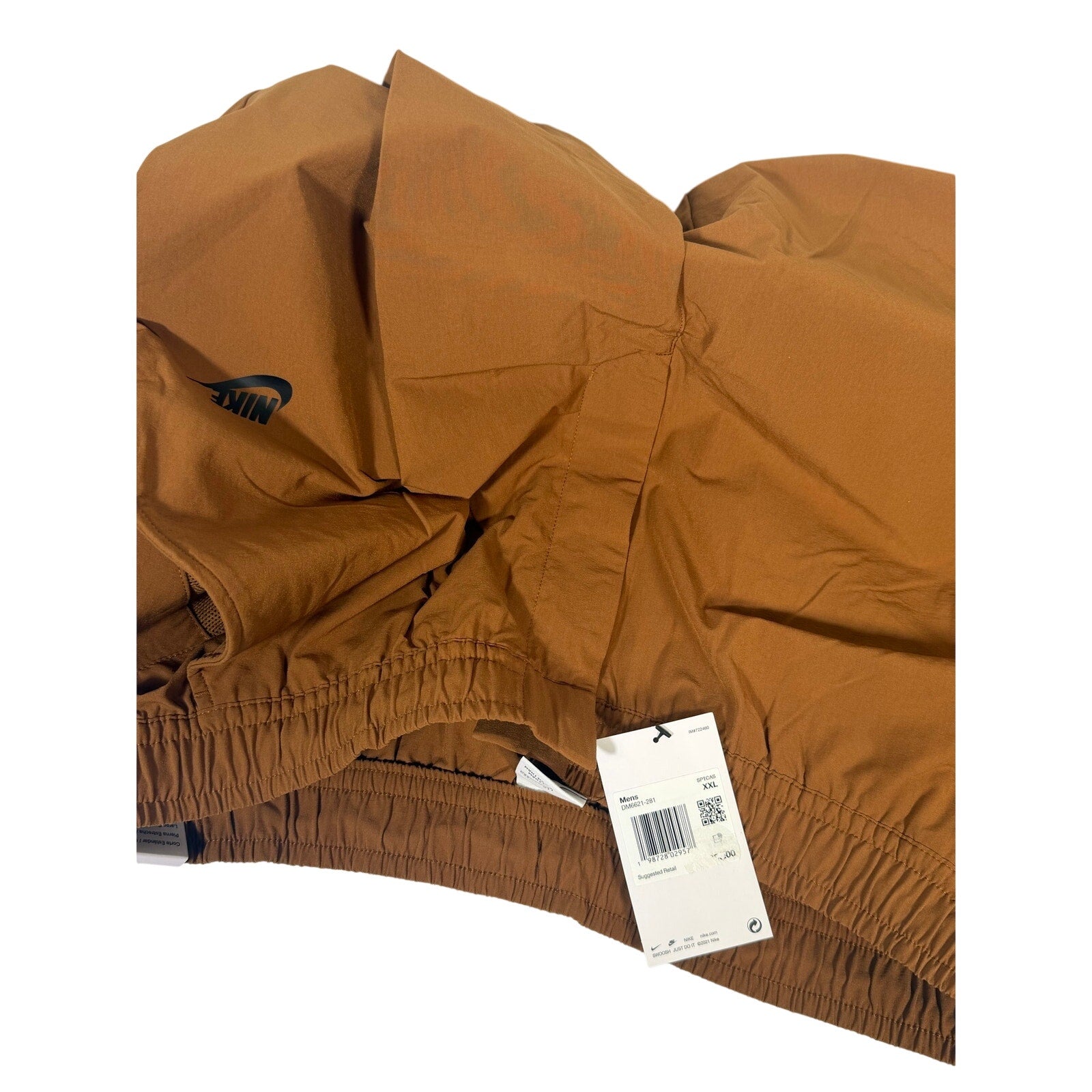 Nike Sportswear men's woven brown cacao pants with elastic waist, size XXL, shown in the image.