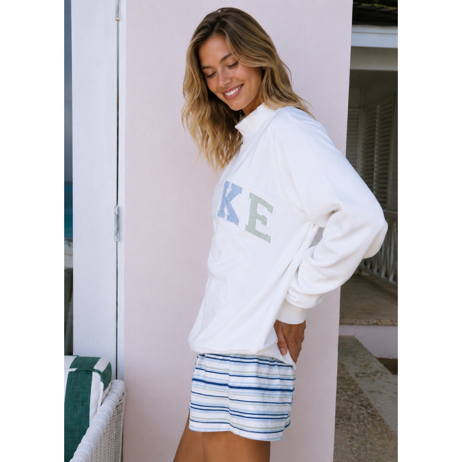 White PARKE Heritage Varsity Mockneck Sweatshirt for women, showing the pullover design with ribbed cuffs and collar.