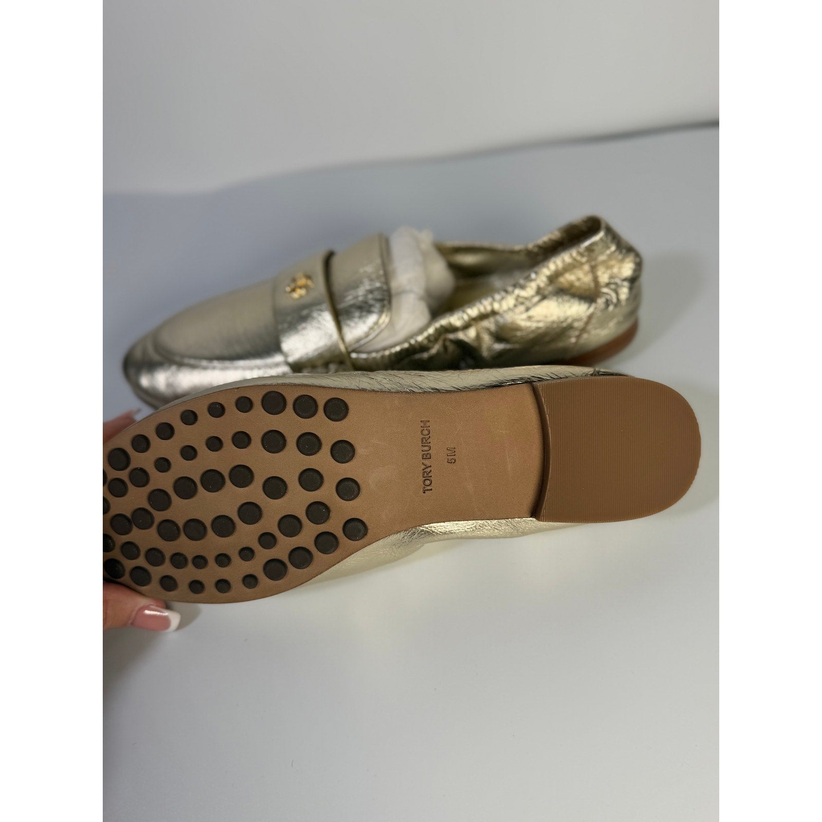 Tory Burch women's gold metallic leather loafers, slip-on flats, size 5M, featuring sleek design and classic style.