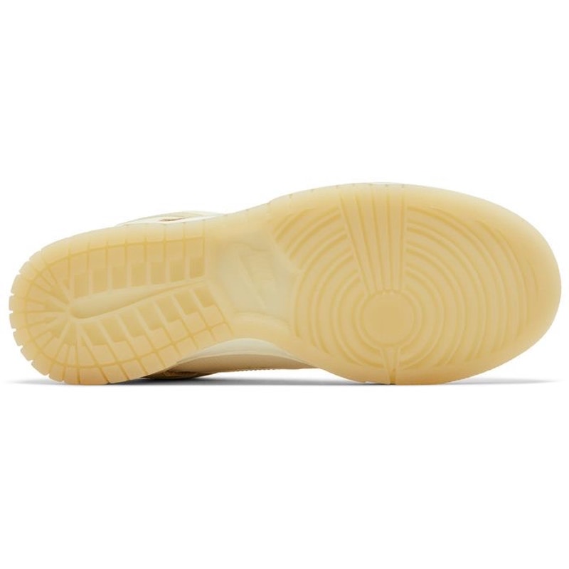 Nike Dunk Low women's sneakers in gold and white, showing the side view with gold accents and white leather panels.