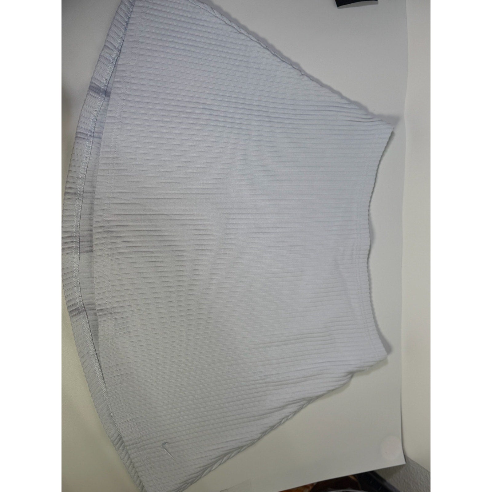 Nike women's ribbed mini skirt in sapphire mist color, size M, featuring a fitted design and textured fabric.