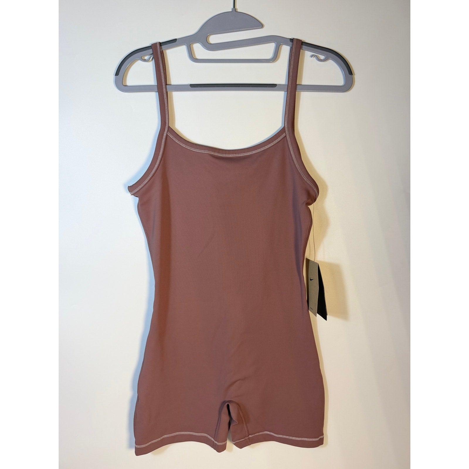 Nike women's mauve training romper, size S, one-piece bodysuit, stylish and comfortable for active wear.