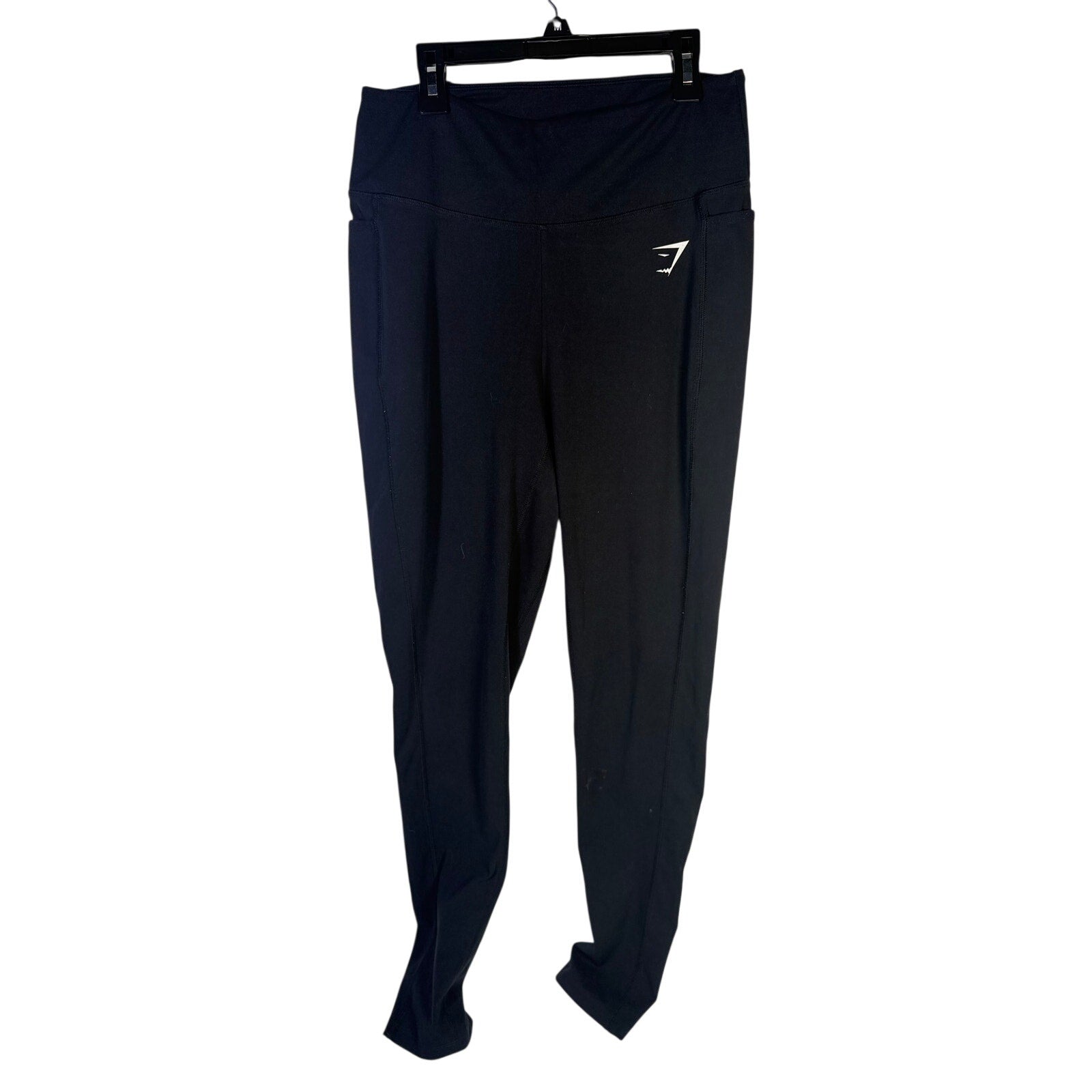 Black Gymshark women's high-waisted leggings with side pockets, size large, shown on a model.
